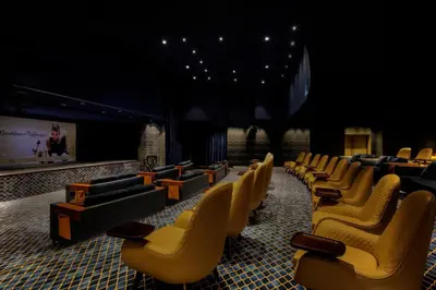 a waiting room with yellow chairs and a screen at Paramount Hotel Dubai in Dubai