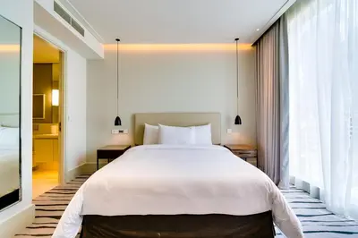 a bedroom with a large bed and a large window at Vida Downtown Residences in Dubai