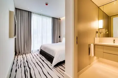a hotel room with a bed and a bathroom at Vida Downtown Residences in Dubai
