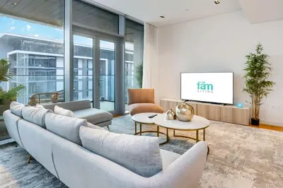 a living room with a couch and a tv at FAM Living Bluewaters - Island Living - Ain Dubai & Sea View in Dubai