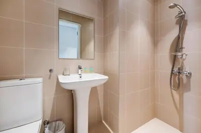 a bathroom with a sink and a shower and a toilet at FAM Living Bluewaters - Island Living - Ain Dubai & Sea View in Dubai