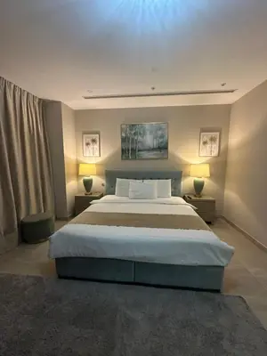 a bedroom with a large bed and two lamps at Magic waves holiday in Dubai