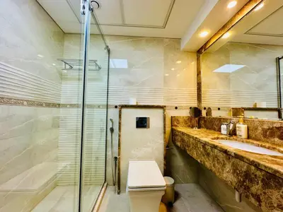 a bathroom with a shower and a toilet and a sink at Magic waves holiday in Dubai