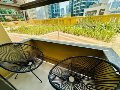 two chairs sitting on top of a balcony at Magic waves holiday in Dubai