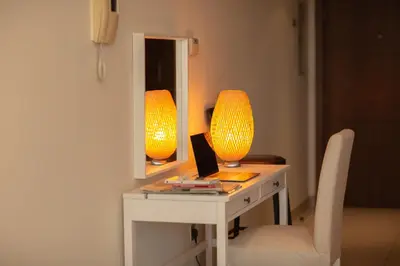 a desk with a mirror and a laptop on it at Prime Retreats - Downtown Dubai in Dubai