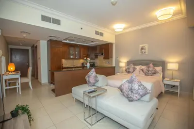 a bedroom with a bed and a white couch at Prime Retreats - Downtown Dubai in Dubai