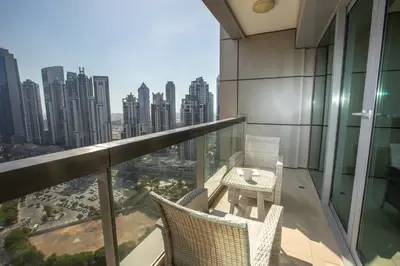 a balcony with a table and chairs and a city at Prime Retreats - Downtown Dubai in Dubai