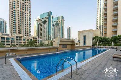 a swimming pool in a city with tall buildings at Westminster Claren Tower - Downtown in Dubai
