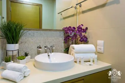 a bathroom with a sink with towels on a counter at Westminster Claren Tower - Downtown in Dubai