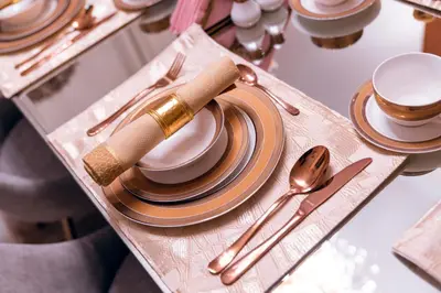 a table with plates and utensils on a tray at Elite Royal Apartment - Full Burj Khalifa & Fountain View - 2 bedrooms and 1 open bedroom without partition in Dubai