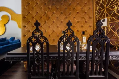 a dining room with black and gold walls and a table at Frank Porter - Reehan 5 in Dubai