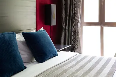 a bedroom with a bed with two blue pillows at Frank Porter - Reehan 5 in Dubai