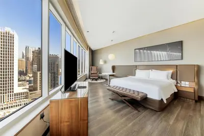 a hotel room with a bed and a large window at Radisson Blu Hotel, Dubai Canal View in Dubai