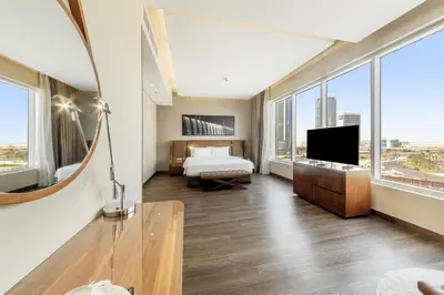 a hotel room with a bed and a television at Radisson Blu Hotel, Dubai Canal View in Dubai