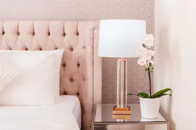 a bedroom with a pink bed and a table with a lamp at Elite Royal Apartment - Full Burj Khalifa & Fountain View - Deluxe in Dubai