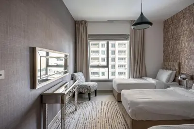 a hotel room with two beds and a window at Bella Vista - 29 Boulevard Downtown Burj Khalifa in Dubai