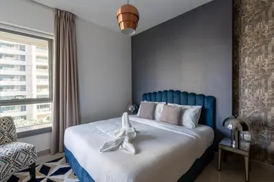 a bedroom with a blue bed with a white bow on it at Bella Vista - 29 Boulevard Downtown Burj Khalifa in Dubai