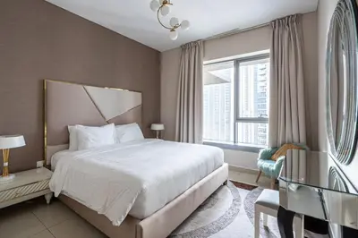 a bedroom with a large bed and a window at Bella Vista - 29 Boulevard Downtown Burj Khalifa in Dubai