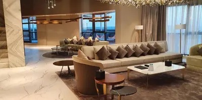 a large living room with a couch and tables at Millennium Place Barsha Heights Hotel Apartments in Dubai