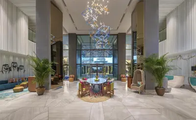 a lobby with a table and chairs in a building at Andaz Dubai The Palm, By Hyatt in Dubai