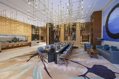 a dining room with a long table and a chandelier at Andaz Dubai The Palm, By Hyatt in Dubai