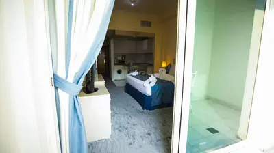 a view of a bedroom with a bed and a window at Green House Hotel Suites & Apartment in Dubai