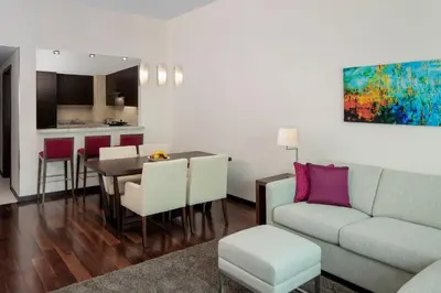 a living room with a couch and a table at Hyatt Place Dubai Jumeirah Residences in Dubai