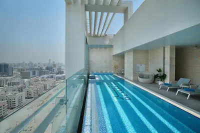 a swimming pool on the top of a building at Millennium Executive Apartments Mont Rose in Dubai