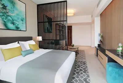 a hotel room with a large bed and a television at Millennium Executive Apartments Mont Rose in Dubai