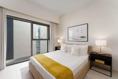 a bedroom with a large bed and a large window at Maison Privee - Elevated Living with Spectacular Burj Khalifa Views in Dubai
