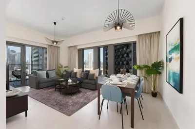 a dining room and living room with a table and chairs at Maison Privee - Elevated Living with Spectacular Burj Khalifa Views in Dubai