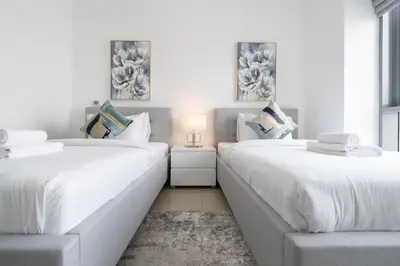 two beds sitting next to each other in a room at Spectacular 2BR with Burj Khalifa and Fountain View in Dubai