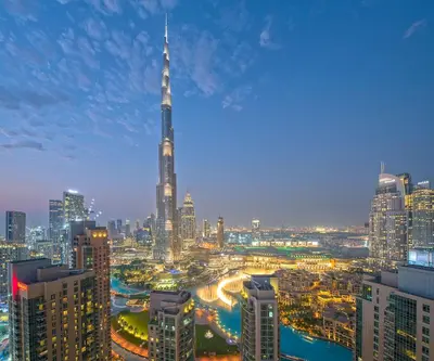 a view of a city at night with a tall building at Spectacular 2BR with Burj Khalifa and Fountain View in Dubai