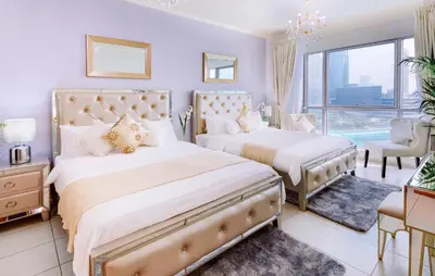 a bedroom with two beds and a window at Elite Royal Apartment - Full Burj Khalifa and Fountain View - Caesar in Dubai