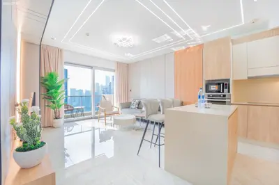 a room with a kitchen and a living room at JW Marriott Full Marina View, Luxury Suites by Gardenia with Direct Access to Marina Mall in Dubai