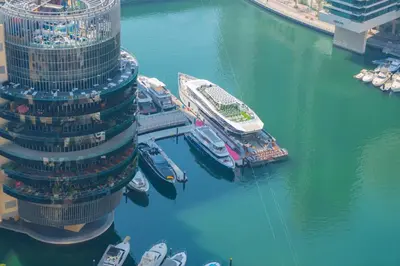 an aerial view of a building with boats in the water at JW Marriott Full Marina View, Luxury Suites by Gardenia with Direct Access to Marina Mall in Dubai