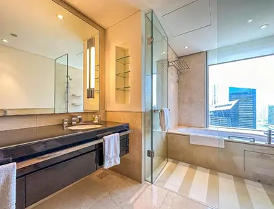 a bathroom with a shower and a sink and a mirror at JW Marriott Full Marina View, Luxury Suites by Gardenia with Direct Access to Marina Mall in Dubai