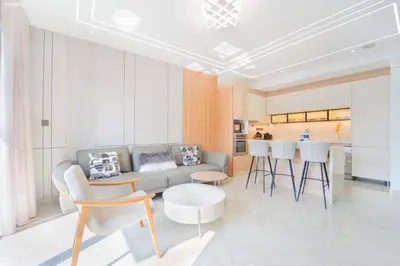 a living room with a couch and a table and chairs at JW Marriott Full Marina View, Luxury Suites by Gardenia with Direct Access to Marina Mall in Dubai