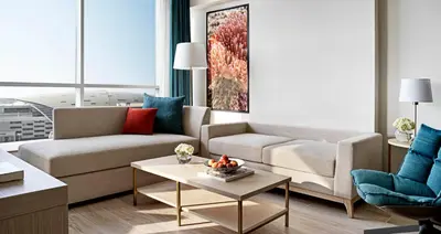 a living room with a couch and a table at Avani Ibn Battuta Dubai Hotel in Dubai