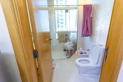 a bathroom with a white toilet and a shower at Masters and Double Rooms For Girls ONLY in Marina, Dubai in Dubai