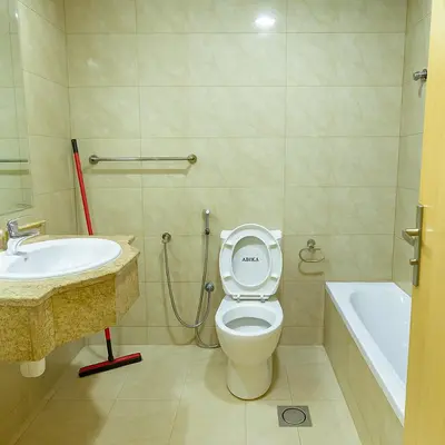 a bathroom with a toilet and a sink and a tub at Masters and Double Rooms For Girls ONLY in Marina, Dubai in Dubai