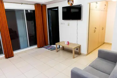 a living room with a couch and a coffee table at La Rivera Rooms for Ladies in Dubai