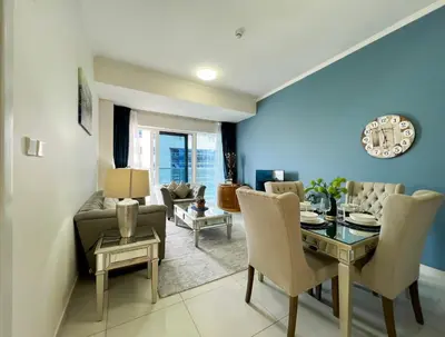 a living room with a table and a dining room at Luton Vacation Homes -sea view -Damac Heights, Dubai Marina -90AB2 in Dubai