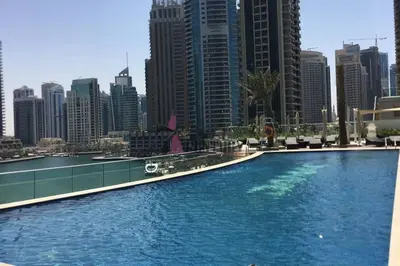 a large swimming pool in a city with tall buildings at Luton Vacation Homes -sea view -Damac Heights, Dubai Marina -90AB2 in Dubai