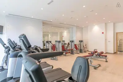 a gym with several treadmills and cardio machines at Luton Vacation Homes -sea view -Damac Heights, Dubai Marina -90AB2 in Dubai