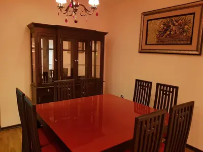 a dining room with a red table and chairs at Al Jazeera Hotel Apartments LLC in Dubai