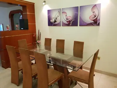 a dining room with a glass table and chairs at Al Jazeera Hotel Apartments LLC in Dubai
