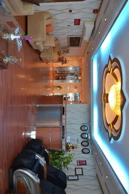 a room with couches and a wall with a painting of arero at Al Jazeera Hotel Apartments LLC in Dubai