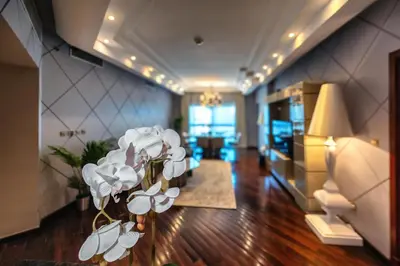 a living room with white flowers in the middle of a room at Nice 2BD apartment in the Palm Jumeirah in Dubai
