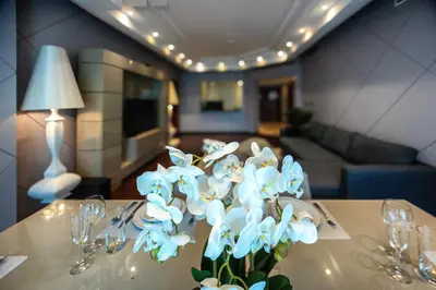a vase of blue flowers sitting on a table at Nice 2BD apartment in the Palm Jumeirah in Dubai